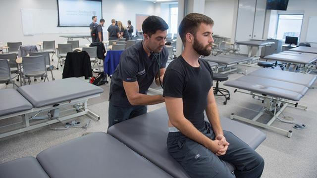 PA student listening to patient breathing