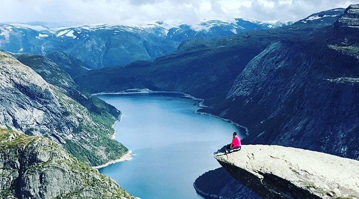 Sitting on a precipice overlooking a lake