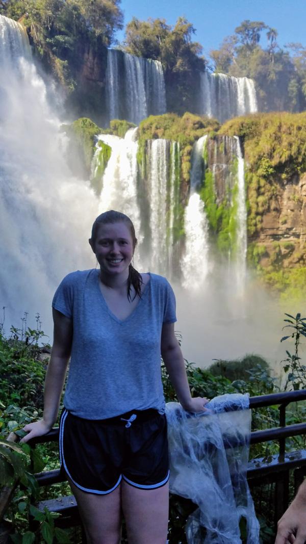 Elizabeth next to a waterfall.